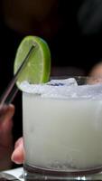 Cooking process Step by step Close up of a professional bartender is mixing gin tonic with professional crystal ice cubes to customers at the bar or disco club. video