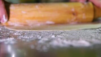 roll out the dough into a thin layer Process of cooking traditional turkish baklava pastry. Unidentified chef making thin filo dough for turkish pistachio dessert baklava video