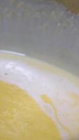Freshly cooked porridge is bubbling and simmering on fire close-up in slow motion video