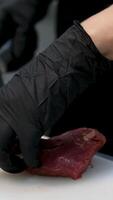 consistency of soft raw meat a piece of beef man cook cuts a fresh red raw fillet in a butcher's shop with a kitchen knife. Slices Premium ribeye meat or marbled beef. Steak production video