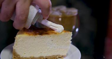 cheesecake with cream Chocolate sauce pouring on cheesecake slice. San Sebastian cheesecake slice with chocolate sauce close up. video