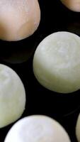 Multi-colored Japanese Mochi ice cream in rice dough and different fillings and tastes. Traditional Japanese video