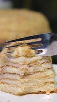 honey cake eat with a fork Medovik cake cut off a small piece structure cream thin layers custard from eggs and milk homemade cooking holiday video