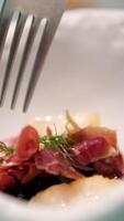 eat with a fork salad with jamon molecular cuisine small portions on a white plate Asparagus salad with ham slices and boiled eggs. video