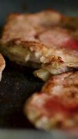 pork neck steak is fried in a frying pan, butter melts during cooking video