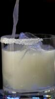 Cooking process Step by step Close up of a professional bartender is mixing gin tonic with professional crystal ice cubes to customers at the bar or disco club. video