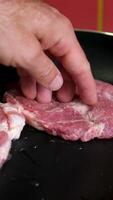 pork neck Raw fresh pork meat cut into slices for frying pork steak is rotated on a kraft wooden board. Close-up. Looping . Top view video