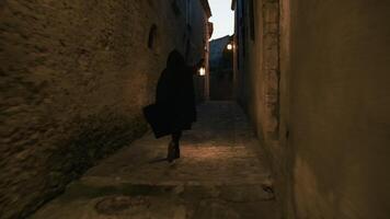 mysterious man runs with a lantern in the medieval town video
