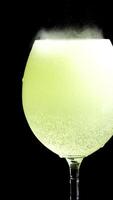 Glass of water with an effervescent vitamin C tablet, black background video