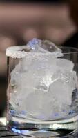 Cooking process Step by step Close up of a professional bartender is mixing gin tonic with professional crystal ice cubes to customers at the bar or disco club. video