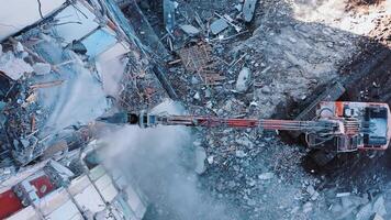 Hydraulic machinery working to get rid of the rubbish in a demolition site. High reach demolition excavator.View from above. video