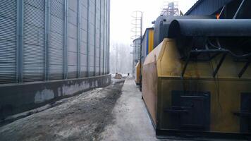 Going around the premises at modern elevator factory. Circle movement around the furnace buildings at granary. Quick motion. video