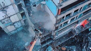 Process of dismantling a structure after an earthquake. Destruction of walls and concrete blocks that were broken by the earthquake. Excavator dismantling high buildings. video