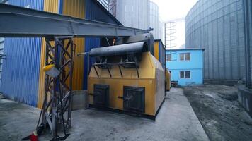 Exterior of the elevator furnace premises with a long orthogonal tube. View of the exterior with gradual distancing. Huge tanks at the backdrop. video