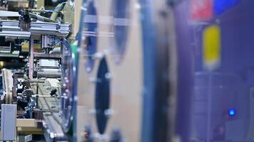 Big round rotating mechanism at the diaper production factory. A number of working devices at the backdrop. video