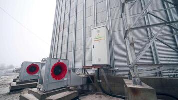 Big factory cistern exterior construction. Huge modern elevator premises with big ventilators. Circle view with approximation to a locker with buttons. video