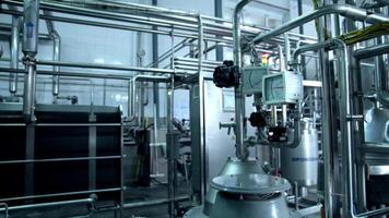 Complex pipe system with sensors at milk production factory. Ramified pipeline system for dairy manufacturing company. Big light premise with tanks and pipes for milk factory. video
