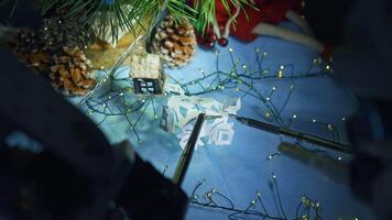 Robotic arms with tiny scissors and claw holding and cutting the paper snowflake. Da Vinci surgical system capabilities to sophisticated work. Close up. video