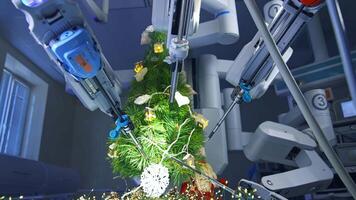 Robotic arms surround Christmas tree to decorate it. Modern medical equipment ornate fir-tree in the operation room. Precise manipulators put a paper snowflake on the fir-tree. video