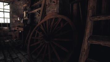 Vintage wooden wheel and rustic tools in a dimly lit workshop setting video