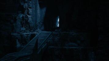 Stairway leading into a mysterious cave illuminated by dim light video