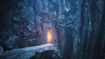 Mysterious entrance within a rocky cliff illuminated by soft light video