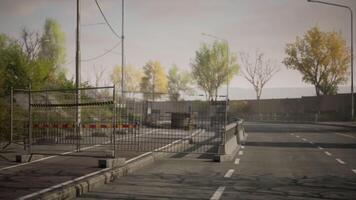 Abandoned road with barriers and trees in the background during daytime video