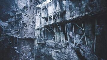 Exploring the ancient cliffs and wooden structures in an abandoned quarry site video