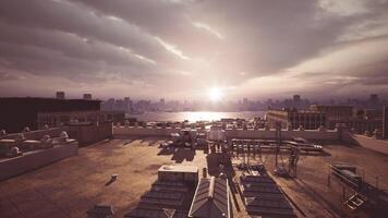 Sunset view over city skyline from rooftop with clouds and urban landscape video
