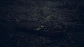 Abandoned boat resting on a deserted shore under dark clouds video