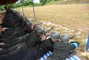 A group of soldiers are lined up and are holding guns photo