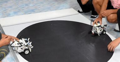 Two robots are on a black surface.2 photo
