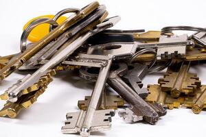 Collection of various keys on a white background with bright highlights photo
