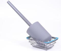 Cleaning tool resting in a shopping basket on a white background photo