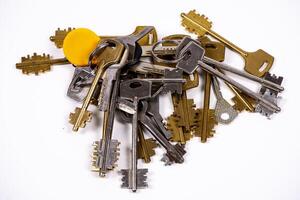 Collection of assorted keys on a white background photo