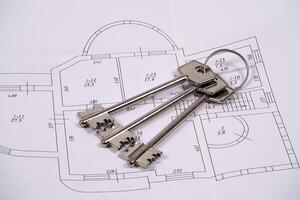 Keys displayed on architectural plan in workspace setting photo