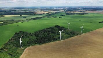 Windmills in summer in a green field.large windmills standing in a field near the forest.Europe, Belarus photo