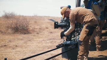 Filming in the steppe. The operator moves the camera along the slider. video