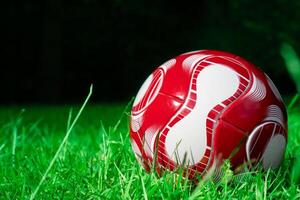 red soccer ball on the field photo