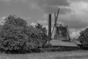 old tractors at a windmill photo