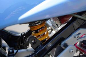 close up of monoshock spare parts from the 4-Stroke underbone motorbike category, yellow pear. photo