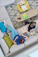 Top View of Mother and Daughter Enjoying a Fun Board Game on the Couch at Home photo