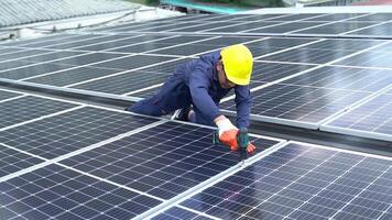 A Technician using drill installing solar cells. video
