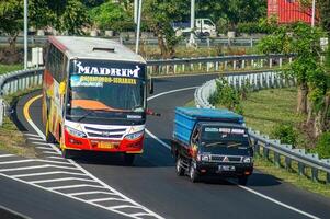 an inter-city bus named Dali Mas that was reckless or speeding on the toll road overtook a pick-up car, Indonesia, 16 July 2024. photo
