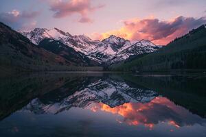 nature background Alpenglow and SnowCapped Peaks Reflected in Serene Lake photo