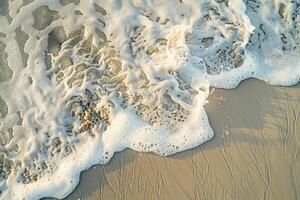 Sandy Beach nature background with Waves and Foam Patterns photo