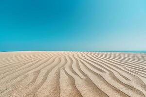 Smooth rippled sand patterns under clear blue sky at midday background nature photo