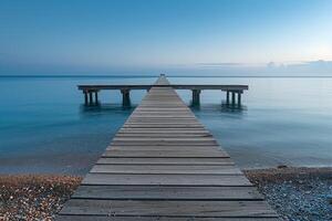 Wooden Pier Stretching into Calm Ocean Waters in Nature Background photo