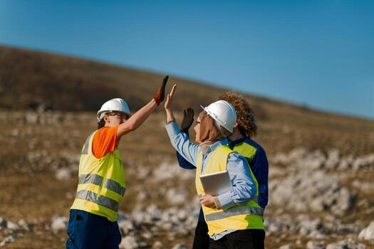 Engineers Collaborating in the Field to Inspect and Optimize Electric Turbines. photo