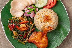 Simangunsong rice is a combination of stir-fried rice with shrimp paste and fried chicken photo
